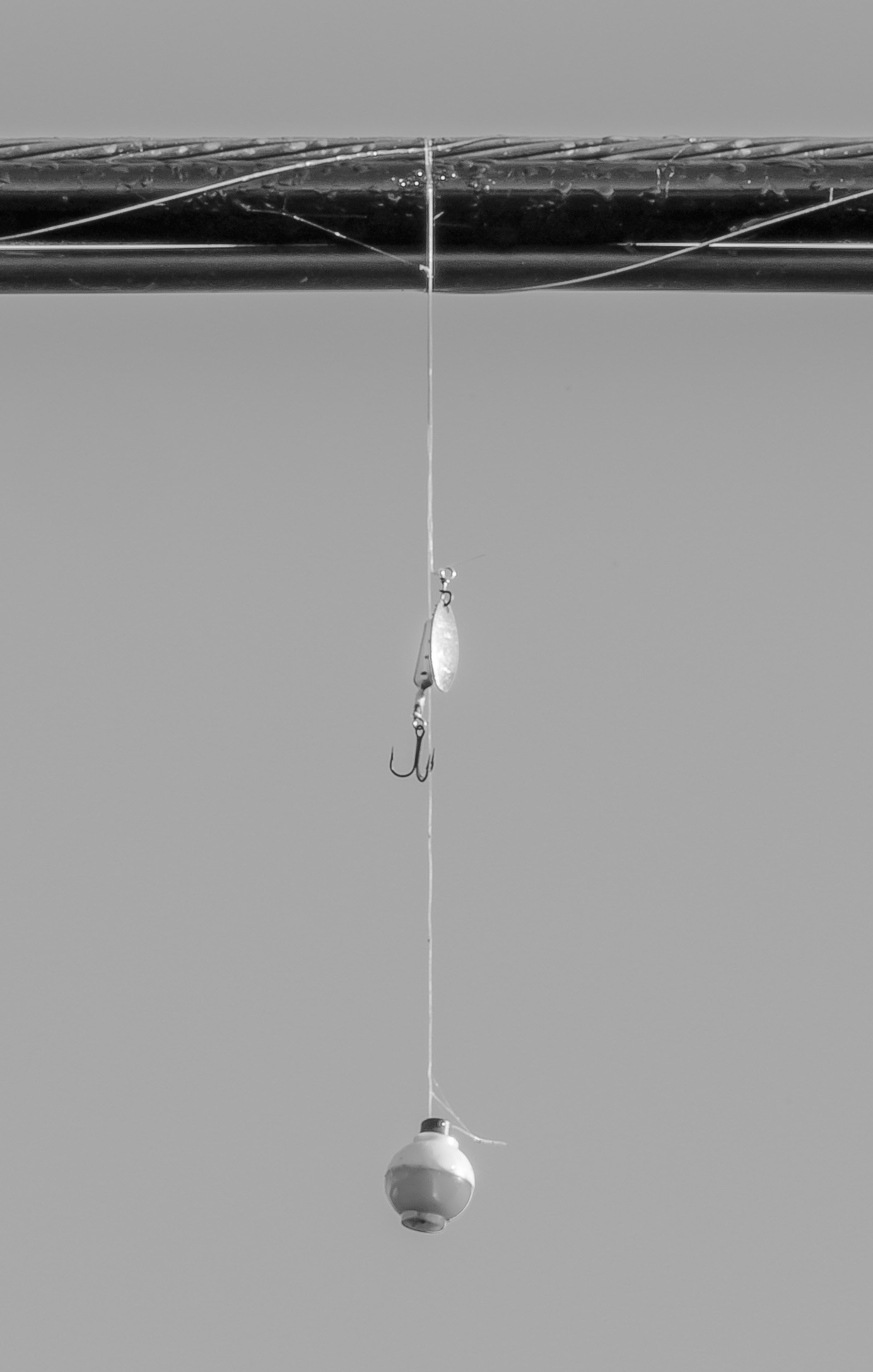 fishing lure and float hanging from utility line